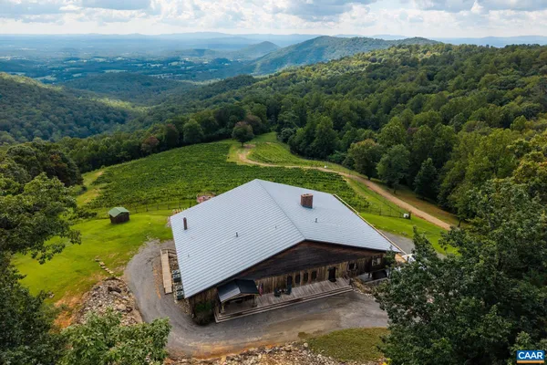 an aerial view of a house with pool and mountain view