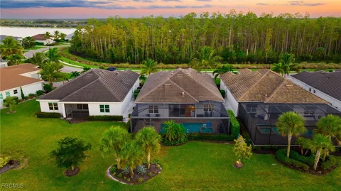 an aerial view of a house with backyard garden and outdoor seating