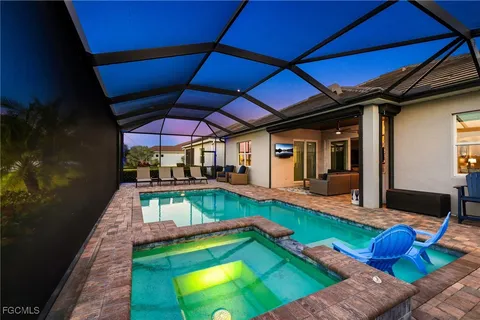 a view of a backyard with chairs under an umbrella