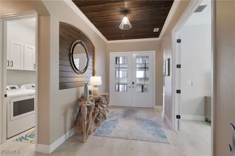 a view of a hallway with washer and dryer