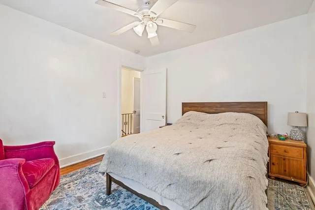 a large bed sitting in a bedroom next to a chandelier