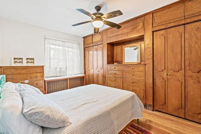 a bedroom with a bed dresser and a window