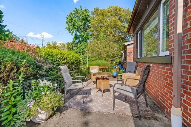 a backyard of a house with table and chairs
