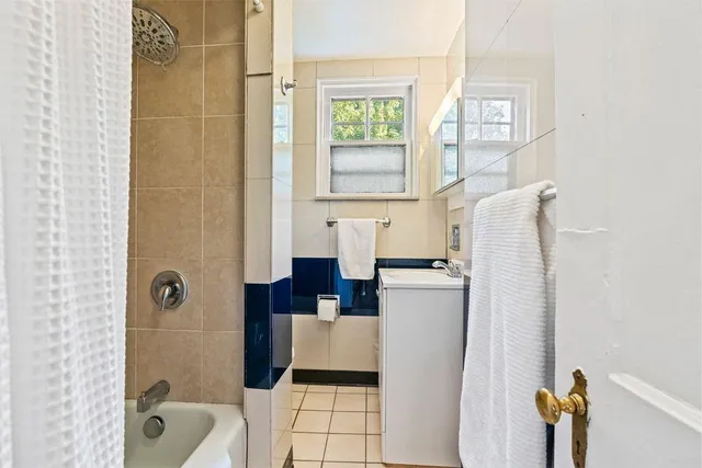 a bathroom with a tub and shower