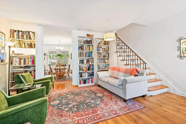 a living room with furniture and a book shelf