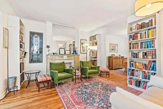 a living room with furniture and a book shelf