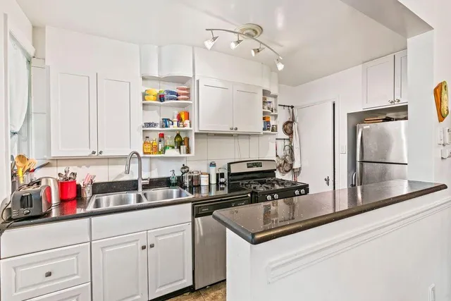 a kitchen with refrigerator a sink and cabinets
