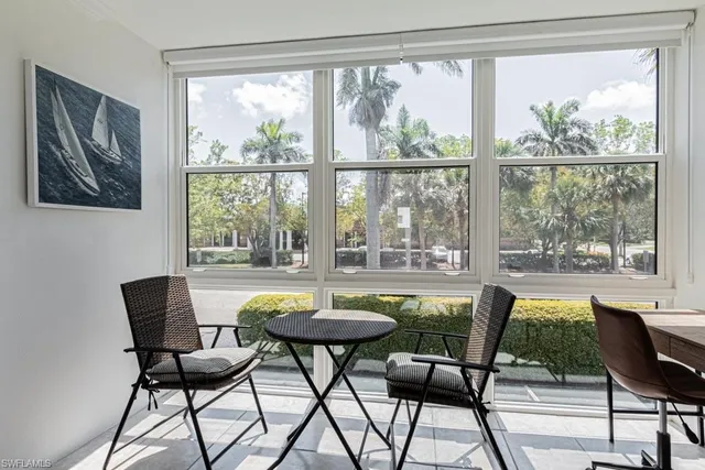 a view of a dining room with furniture a chandelier and wooden floor