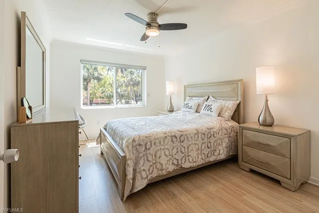 a bedroom with a bed mirror and window