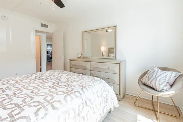 a bedroom with a bed and a chair