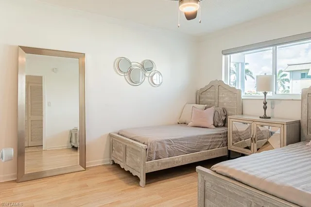 a bedroom with two beds and a large window