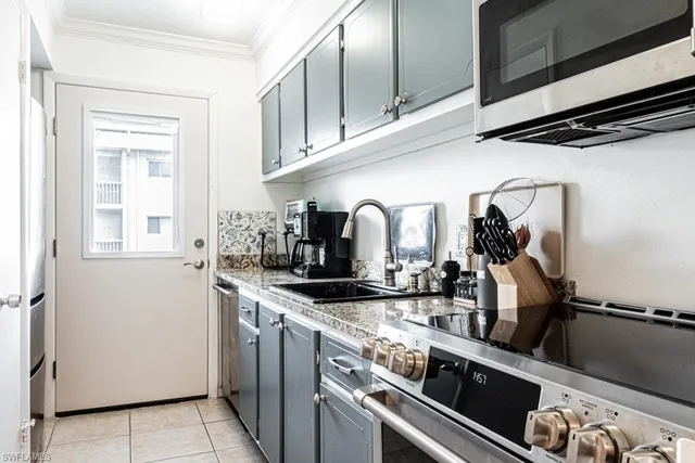 a kitchen with a sink appliances and cabinets