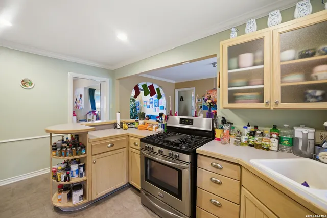 a kitchen with a sink stove and cabinets