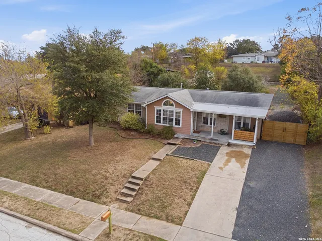 a aerial view of a house next to a yard