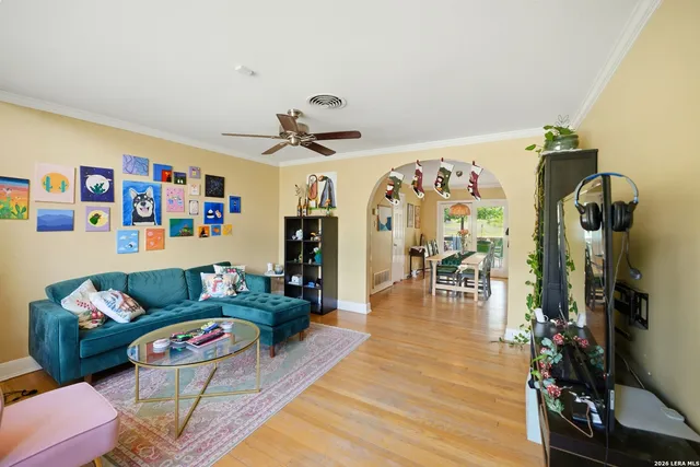 a living room with furniture and wooden floor