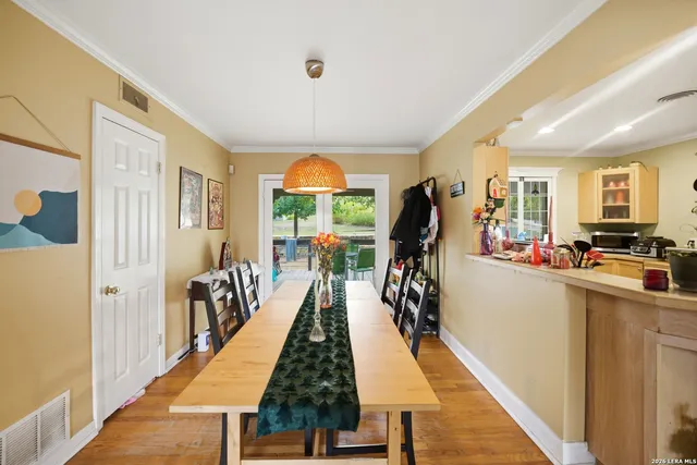 a dining hall with stainless steel appliances granite countertop a stove and cabinets