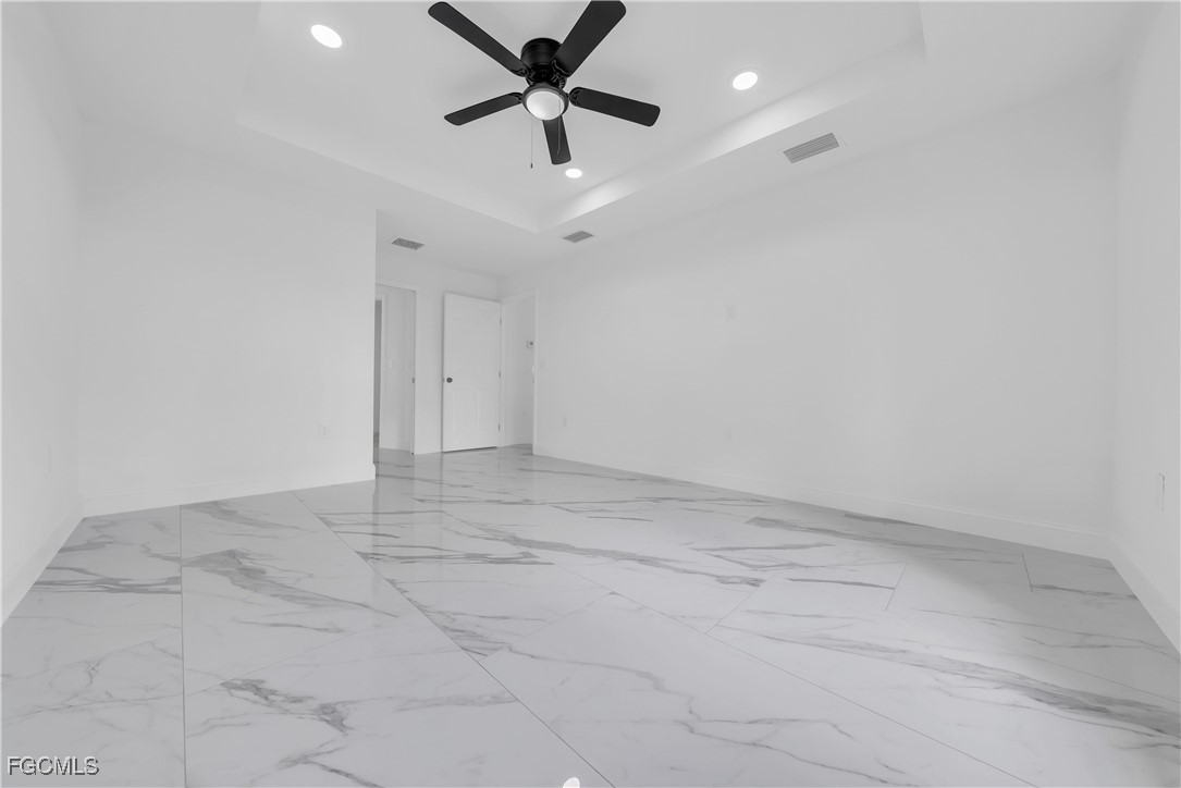 7602 18th Place LaBelle, FL 33935 - Photo 13 of 30 en empty room with ceiling fan and window