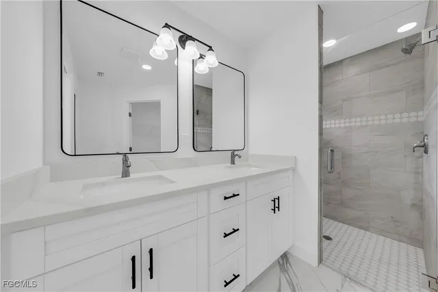 a bathroom with a double vanity sink and mirror
