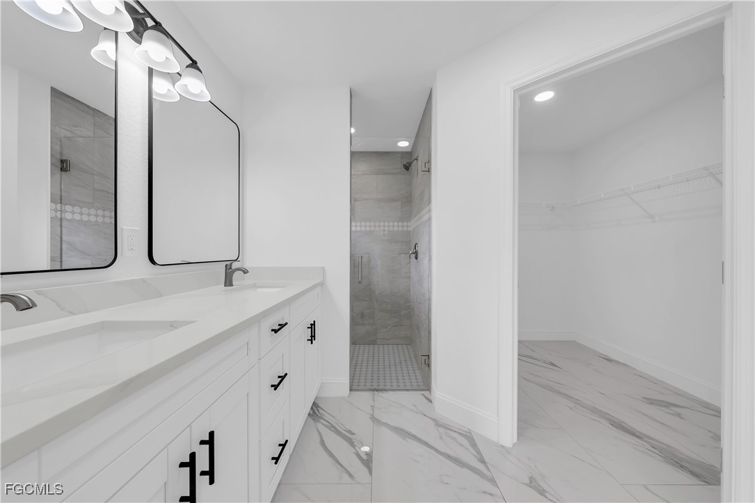 7602 18th Place LaBelle, FL 33935 - Photo 17 of 30 a bathroom with a double vanity sink and mirror