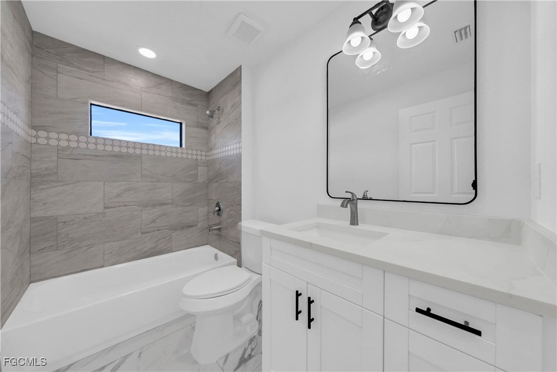 7602 18th Place LaBelle, FL 33935 - Photo 20 of 30 a bathroom with a sink a toilet and shower