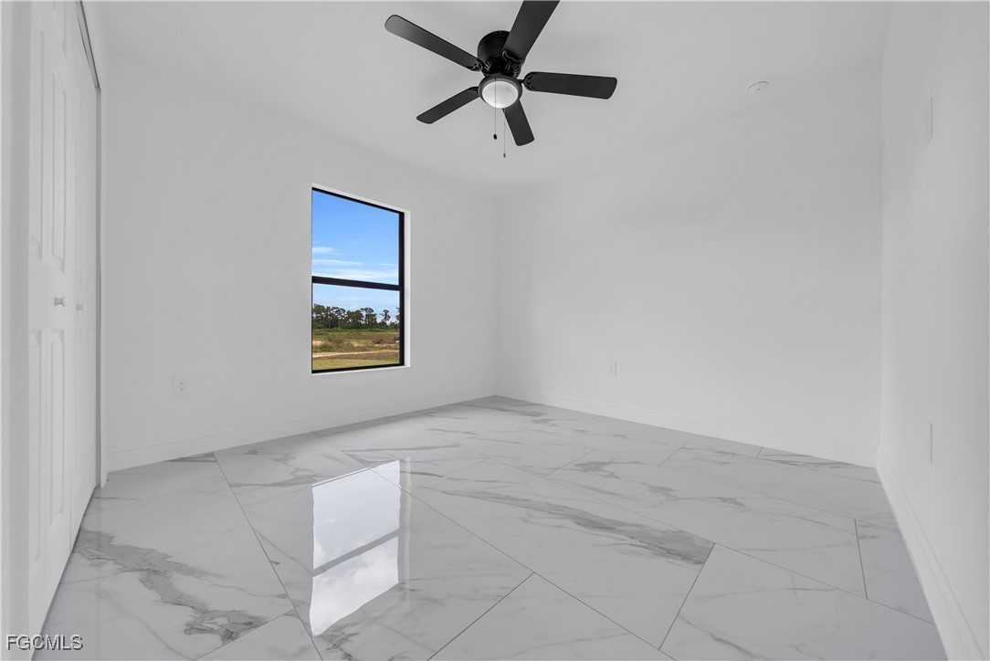 7602 18th Place LaBelle, FL 33935 - Photo 22 of 30 an empty room with windows and fan