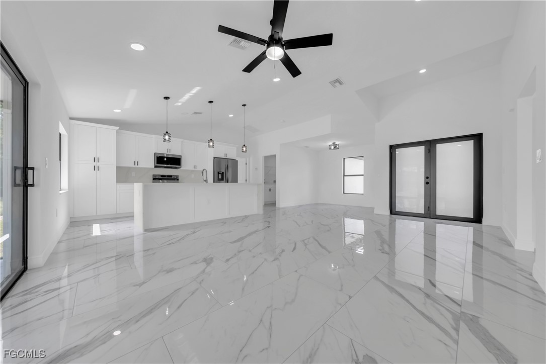 7602 18th Place LaBelle, FL 33935 - Photo 5 of 30 a view of a kitchen with wooden floor and a refrigerator