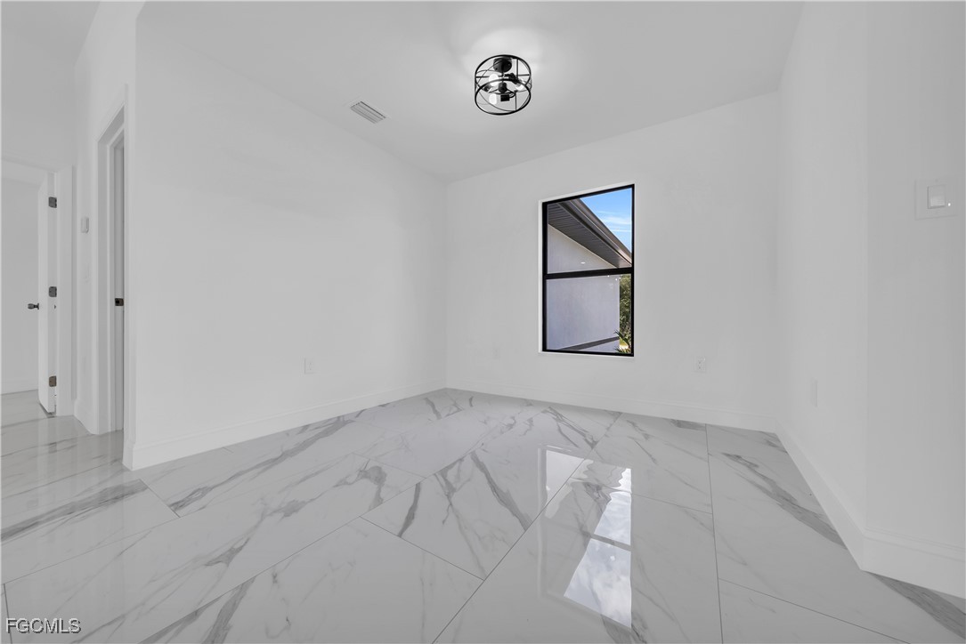 7602 18th Place LaBelle, FL 33935 - Photo 7 of 30 an empty room with a window