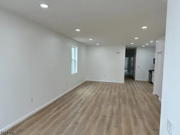 a view of an empty room and a window