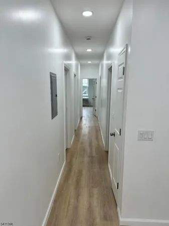 a view of a hallway with wooden floor