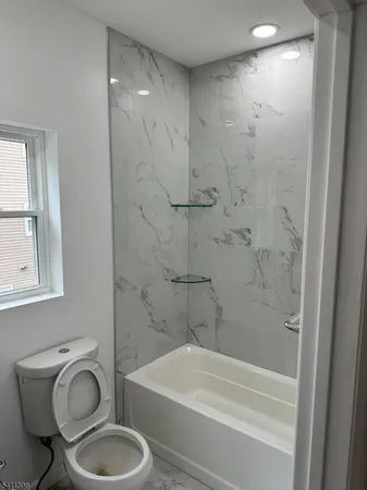 a bathroom with a toilet a sink and bathtub