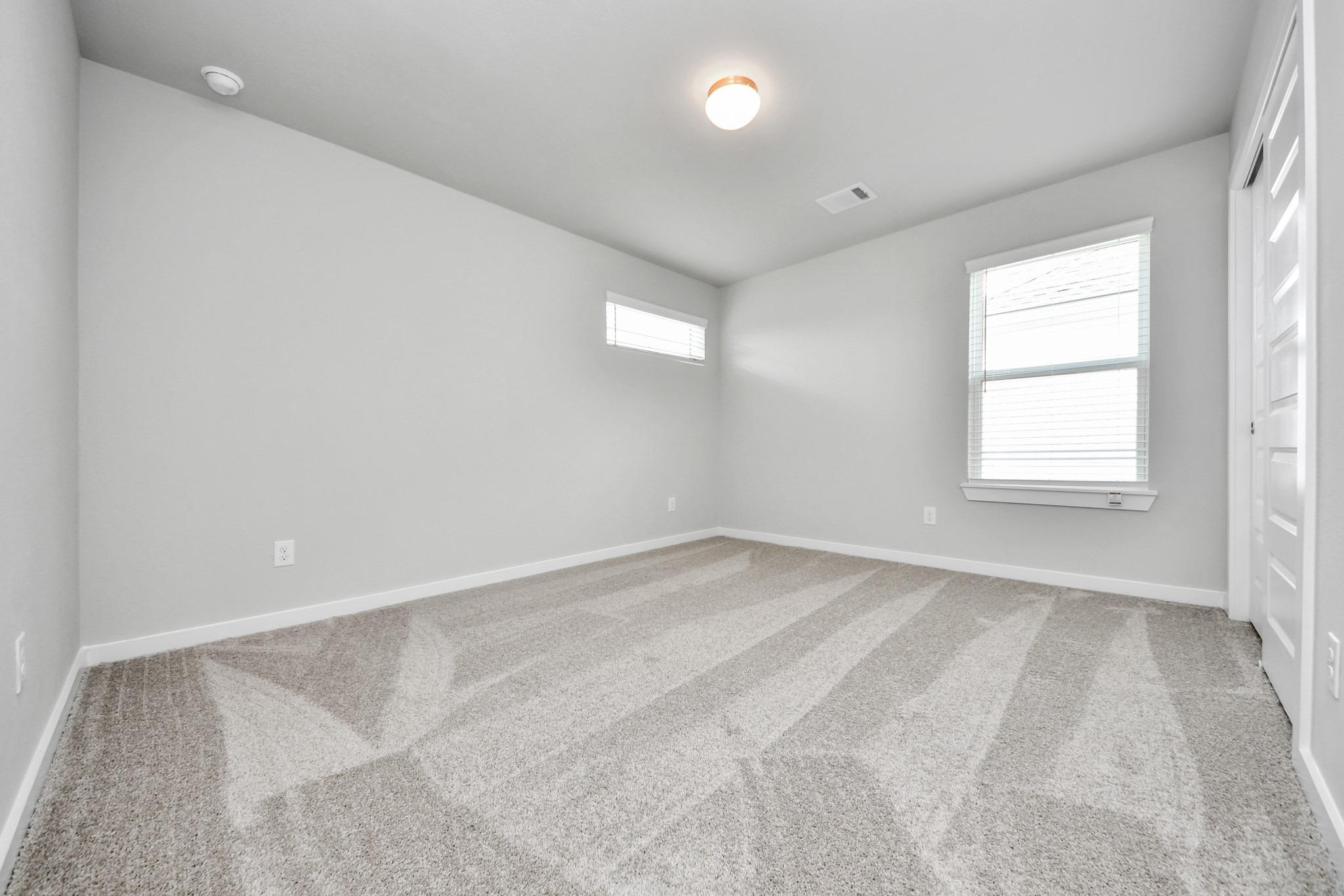 11106 Tulip Rdg Trail Houston, TX 77044 - Photo 27 of 34 Generously sized secondary bedrooms featuring spacious closets, soft and inviting carpeting underfoot, large windows allowing plenty of natural light, and the added touch of privacy blinds for your personal retreat. Sample photo of completed home with similar floor plan. Actual colors and selections may vary.