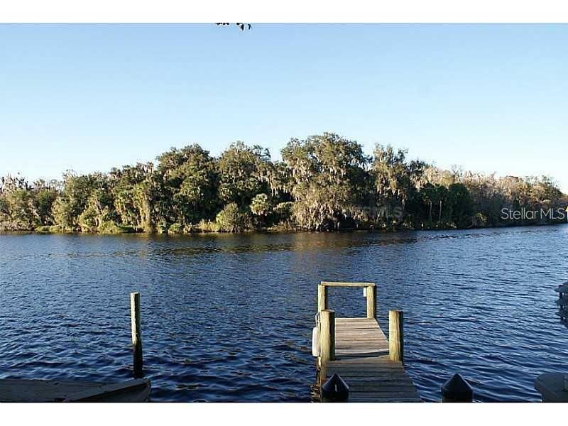 205 Sher Lane DeBary, FL 32713 - Photo 14 of 15 a wooden floor near a lake