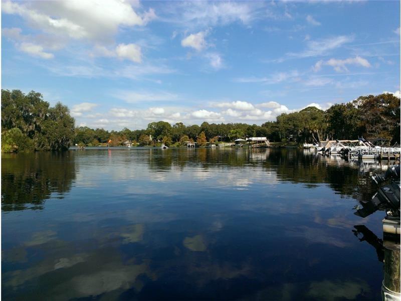 205 Sher Lane DeBary, FL 32713 - Photo 10 of 15 a view of a lake with houses in the back