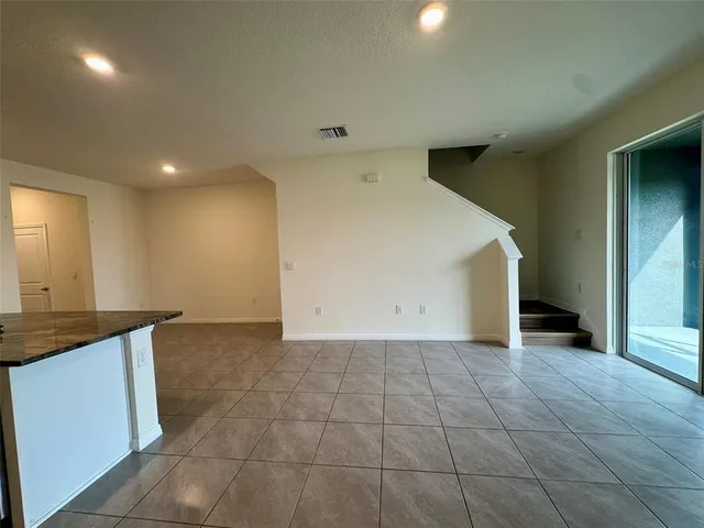 a view of a room with wooden floor and stairs