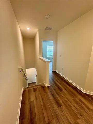 a bathroom with a granite countertop sink a mirror and a bathtub