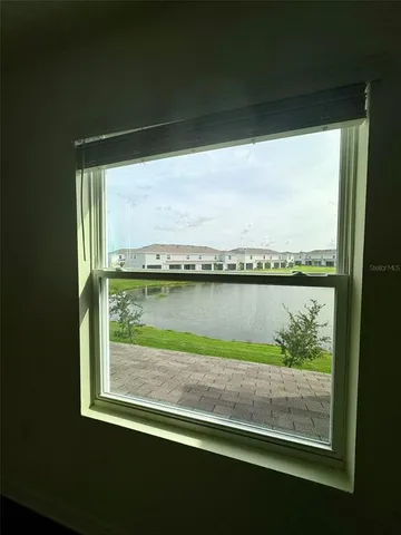 an empty room with wooden floor and white wall