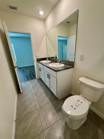 a view of a room with wooden floor and bench