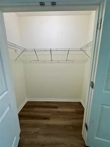 front view of a house with a yard and palm trees