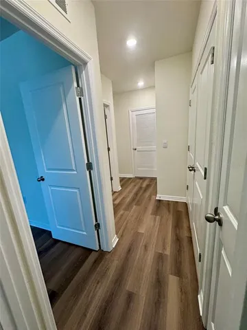 a front view of a house with a garden and parking