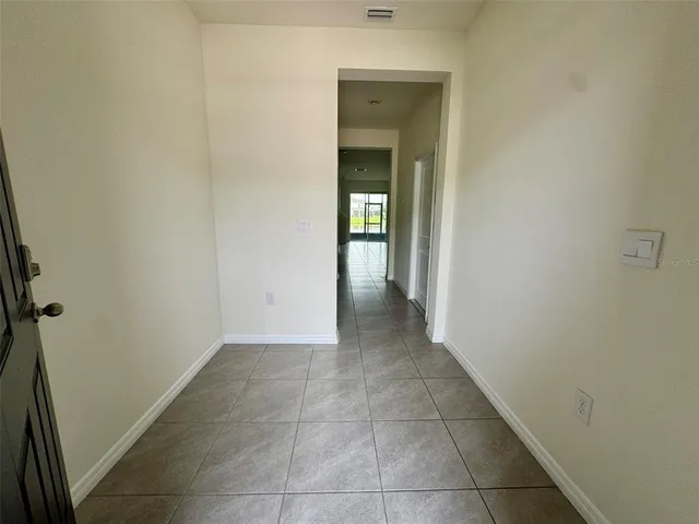 a view of a hallway with wooden shelves
