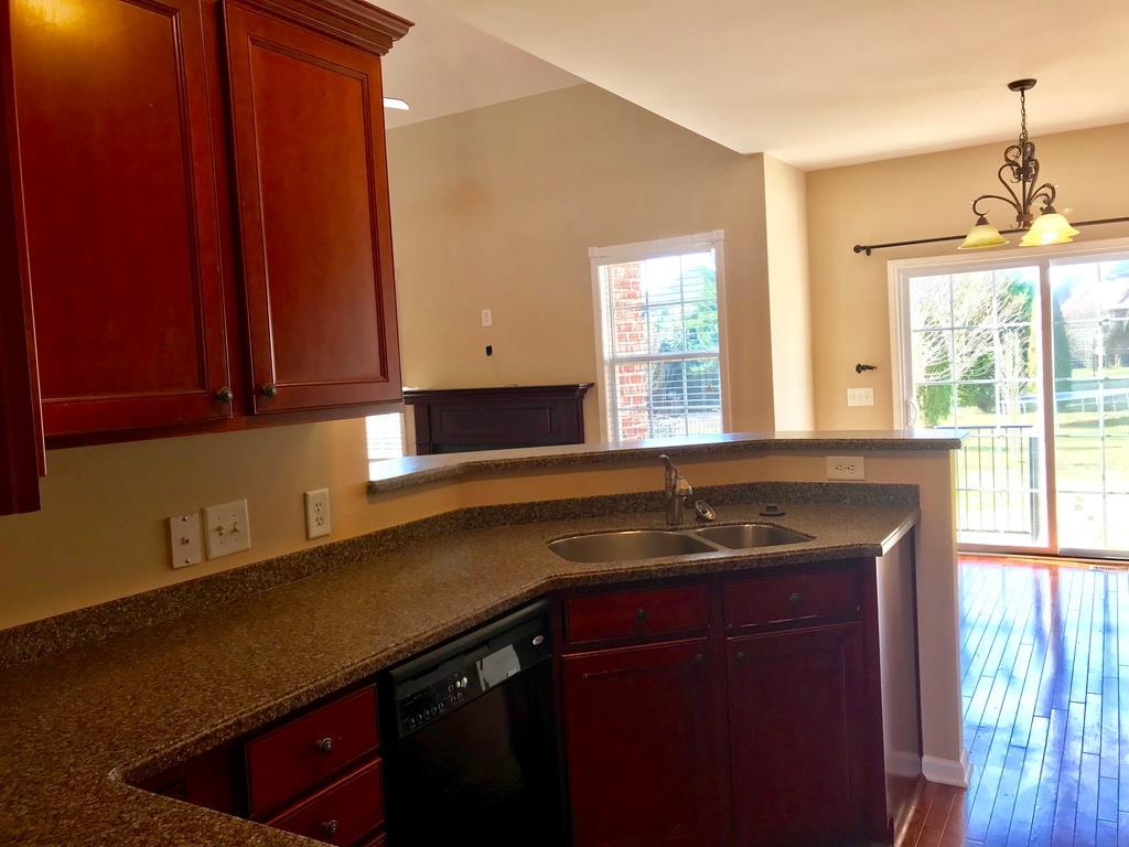 118 Ruland Circle Hendersonville, TN 37075 - Photo 4 of 30 a kitchen with granite countertop a sink a stove cabinets and wooden floor
