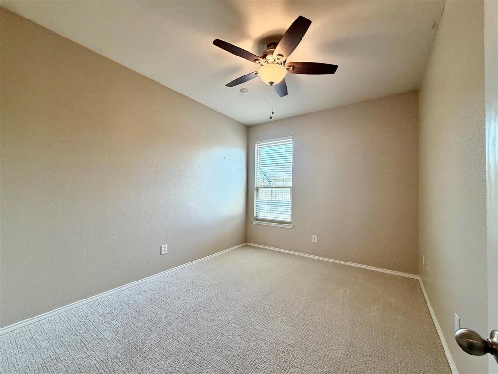 5817 Deck House Road Fort Worth, TX 76179 - Photo 10 of 19 Carpeted room featuring a ceiling fan with light fixture, a window with blinds, and neutral painted walls