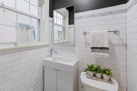 a bathroom with a sink mirror and vanity