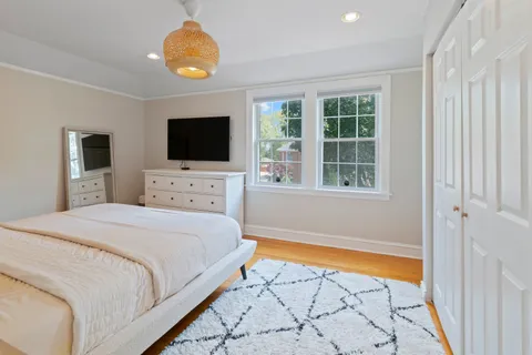 a bedroom with a bed and a flat screen tv