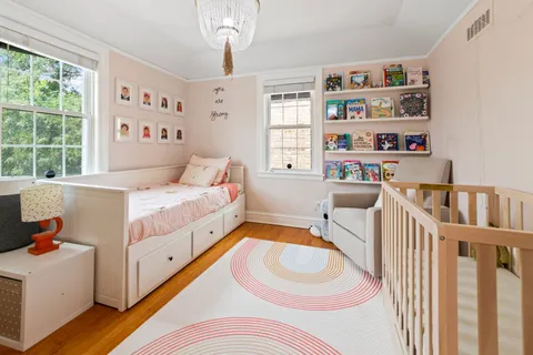 a room with a bed and a book shelf