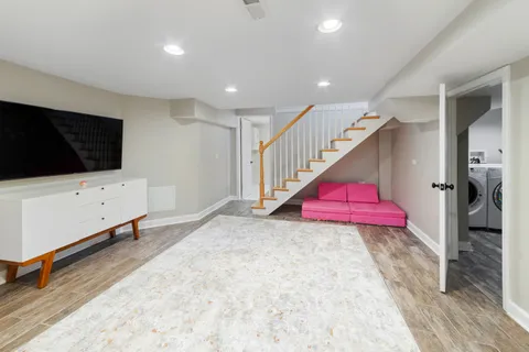 a view of entryway room and hall with wooden floor