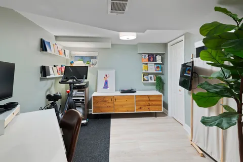 a bedroom with furniture and a flat screen tv