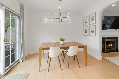 a view of a dining room with furniture wooden floor and a flat screen tv