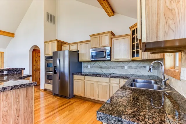 a view of an empty room with a fireplace and a window