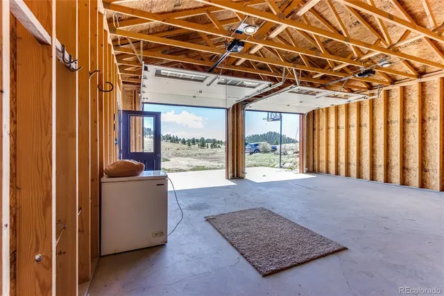 a room with gym equipment and wooden floor